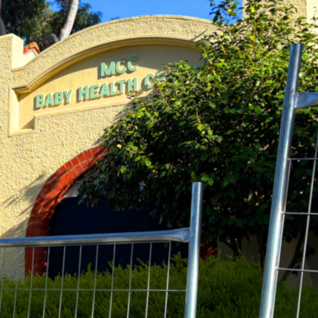 Exterior view of the MCC Baby Health Care building, showing the sign and surrounding greenery.