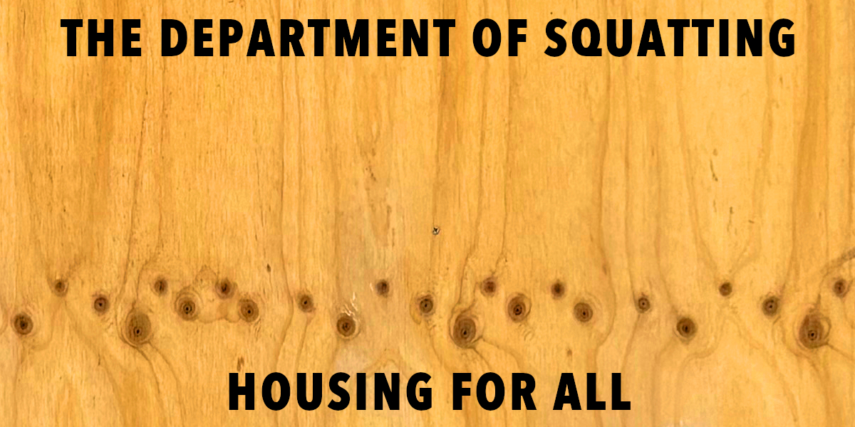 A wooden background featuring large black text that reads 'THE DEPARTMENT OF SQUATTING' and 'HOUSING FOR ALL'.